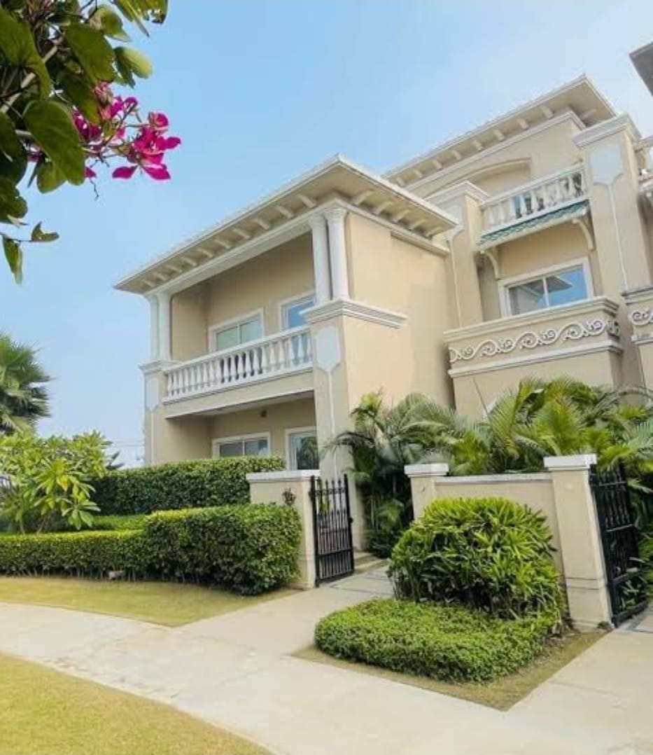 Luxury cream villa with columns and garden
