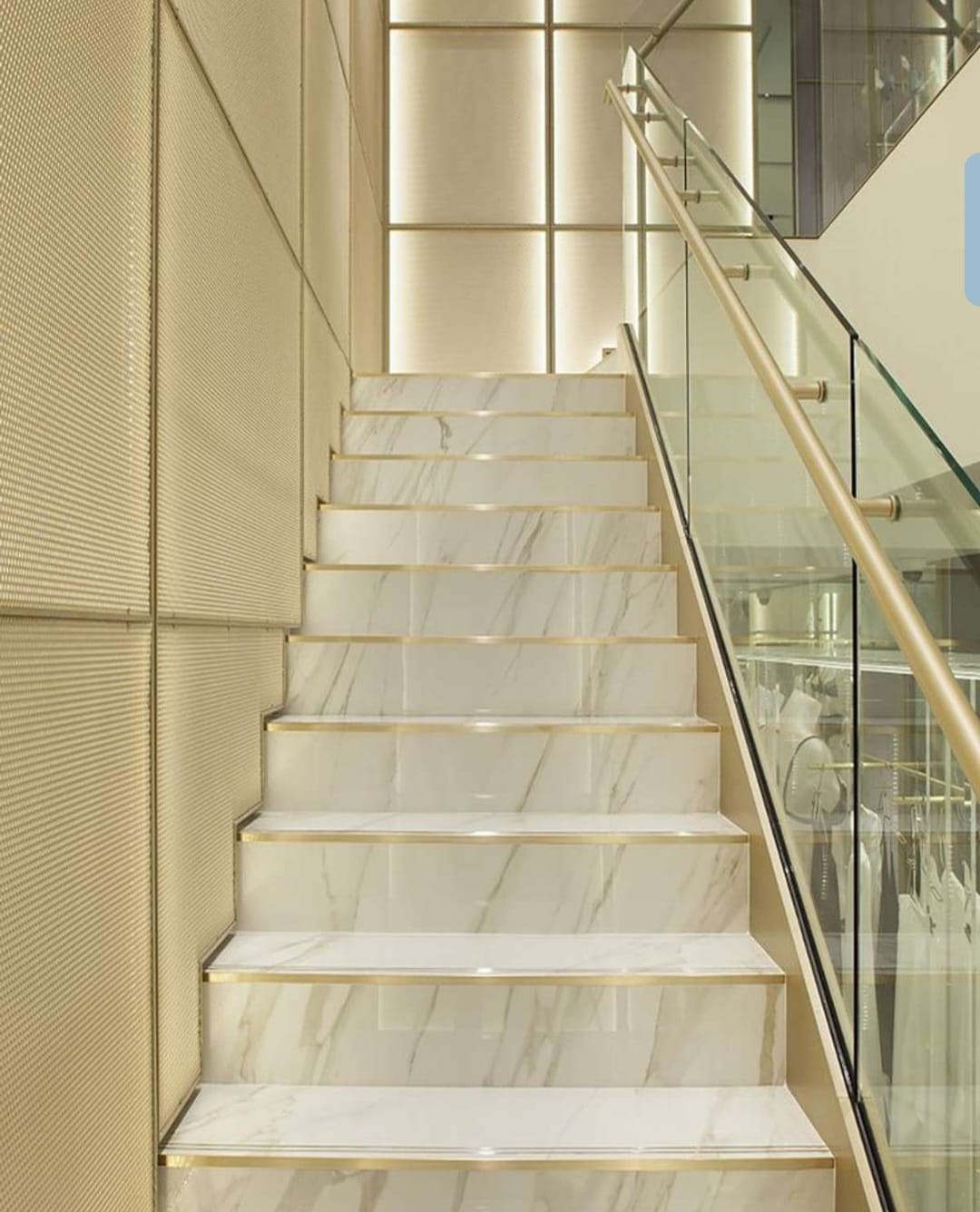 Premium marble staircase with glass and brass railing