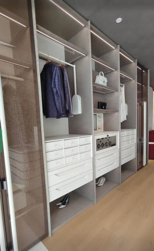 Walk-in wardrobe with glass shutters and lighting for flats