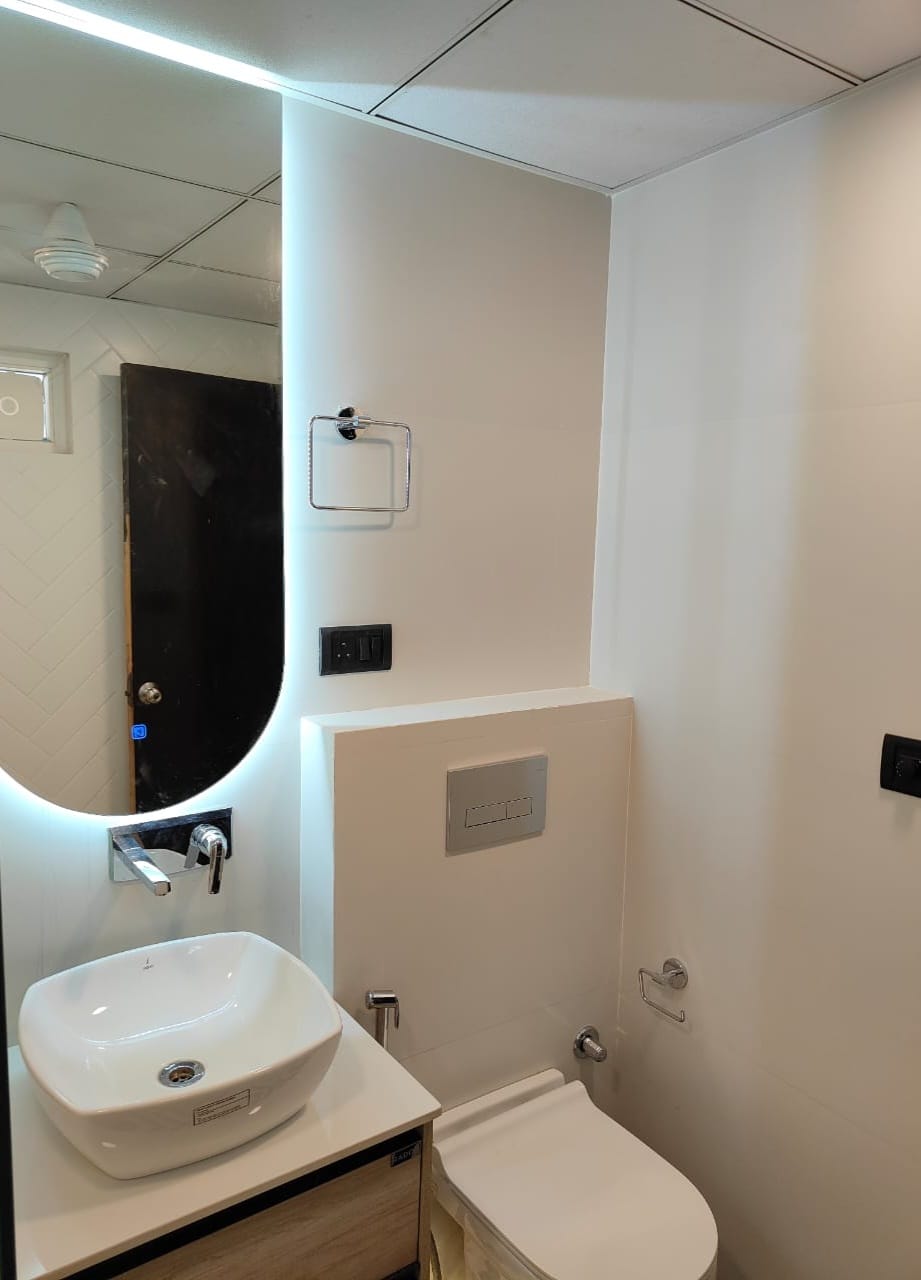 Bathroom with backlit mirror, cove lighting and modular switches